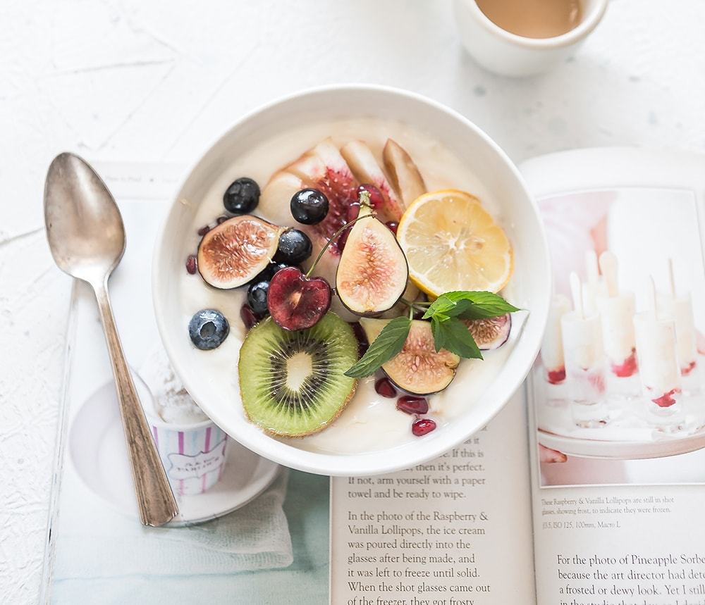 Bowl of yogurt with figs, kiwi and berries