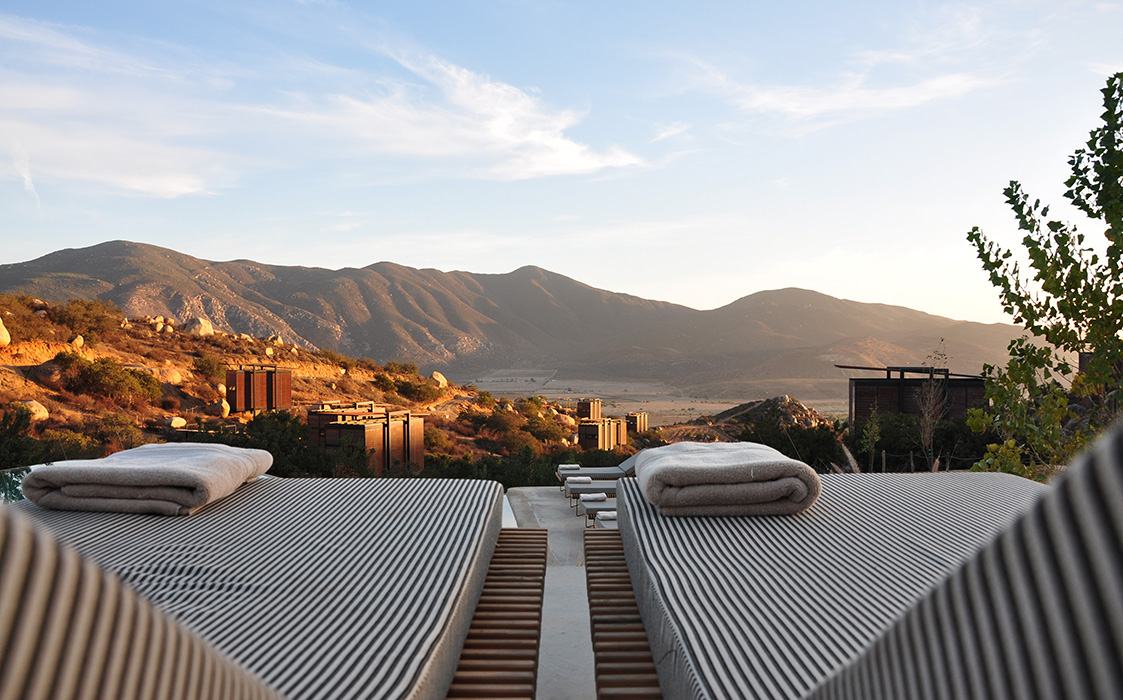 Loungers on the roof terrace facing the valley at sunset