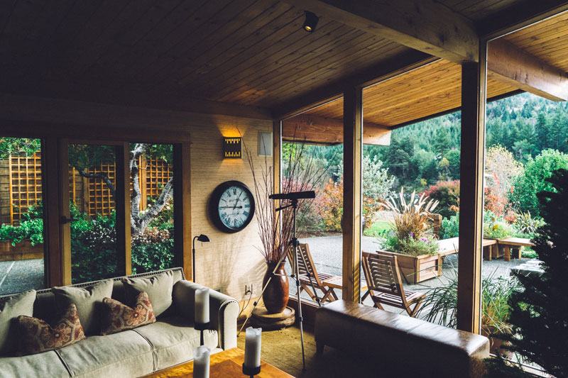The covered veranda with armchairs looking over the garden