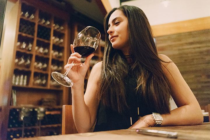 Guest tasting red wine in a cellar
